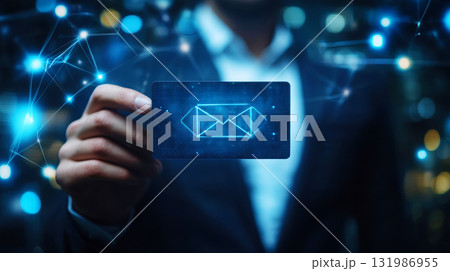 Businessman touching holographic Email Icon and  representing online messaging and connection glowing envelope in technology Businessman touching holographic Email Icon and  representing online messaging and connection glowing envelope in technology 131986955