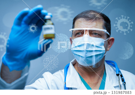 Healthcare professional examines vaccine vial in laboratory setting during pandemic Healthcare professional examines vaccine vial in laboratory setting during pandemic 131987083