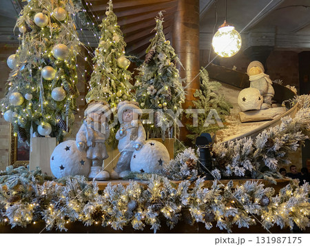 A festive and cosy indoor scene featuring a Christmas or Winter holiday display, likely within a hotel lobby 131987175