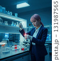 Scientist working in a modern laboratory at night, focused expression 131987565