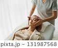 Young woman receiving a facial massage in a bright spa, calm mood 131987568