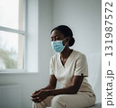 Young Black woman nurse sitting by window in bright medical office 131987572