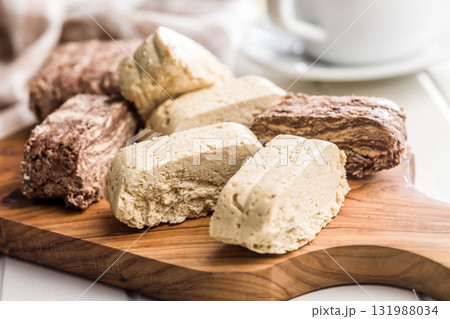 Halva. Sweet oriental dessert on cutting board. 131988034
