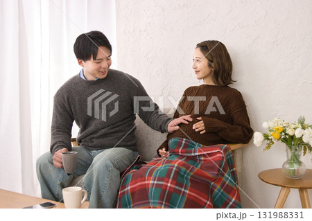 ソファに座ってくつろぐ若い夫婦　妊婦さん 131988331