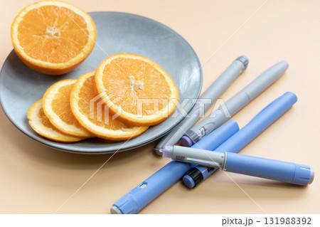 Insulin injection pen for diabetics and weight loss and plate with orange 131988392
