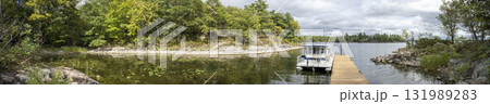 Panoramic view of a bay with a docked houseboat 131989283