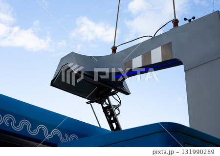 Electric vehicle charging station. Unique design of charging arm with blue LED lights, offering modern look and reflecting innovations in sustainable transportation solutions Electric vehicle charging station. Unique design of charging arm with blue LED lights, offering modern look and reflecting innovations in sustainable transportation solutions 131990289