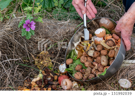 Kitchen waste deposit for compost in the garden 131992039