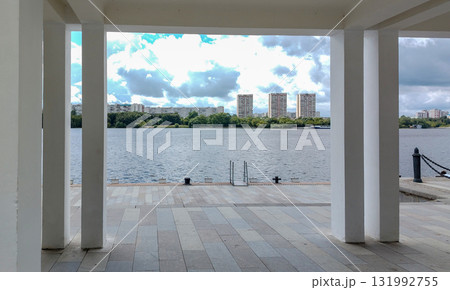 River view framed by white columns of an urban waterfront River view framed by white columns of an urban waterfront 131992755