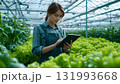 A young female content creator films a promotional video using a smartphone on a tripod, symbolizing digital marketing, social media influence, and modern entrepreneurship. AI Generated 131993668