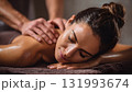 A professional therapist provides a relaxing back massage to a female client, promoting wellness, stress relief, and luxurious spa treatment in a calm setting. AI Generated 131993674