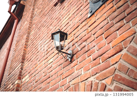 Street lamp on the wall of a brick building Street lamp on the wall of a brick building 131994005