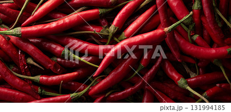 Fresh red chili peppers stacked together in a vibrant market display 131994185