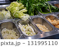 Selection of fresh vegetables in salad bar at the restaurant, including lettuce, shredded cabbage, water spinach and more 131995110