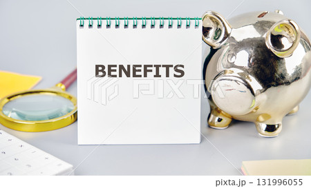 BENEFITS word written in a notebook in a composition with a piggy bank and a magnifying glass. Business concept. Internet concept. 131996055