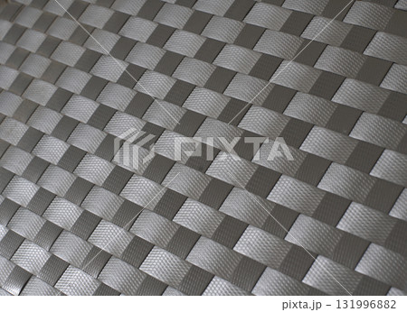 Handmade weave pattern of gray plastic strips texture for mats, baskets or rattan furniture. 131996882
