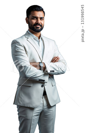 A South Asian male entrepreneur in a crisp white suit, standing confidently with arms crossed, surrounded by glowing blueprints 131998545