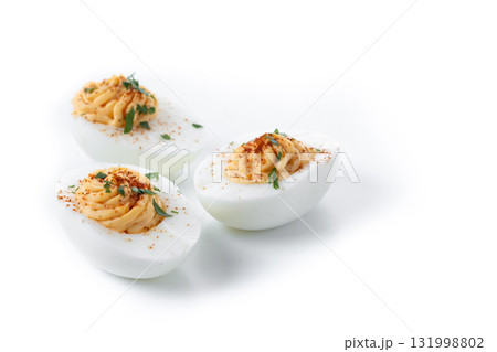 Homemade hard Boiled Deviled Eggs garnished with herbs 131998802