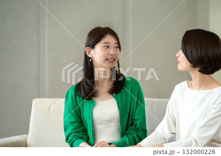 ソファに座って会話をする女性 132000226