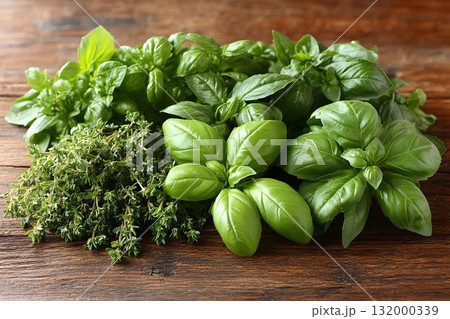 Fresh basil and thyme herbs on rustic wood background 132000339