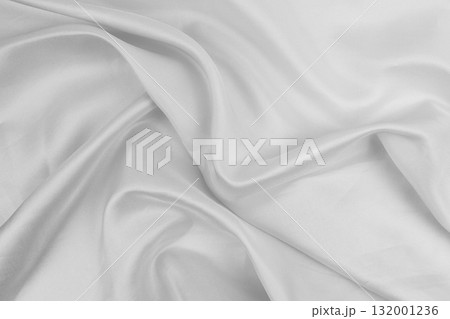 White fabric flowing smoothly on a surface White fabric flowing smoothly on a surface 132001236
