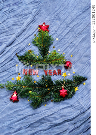 New Year background with branches in the shape of a Christmas tree. 132001249
