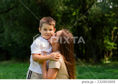 Mother kissing her cute preschool son on cheek. Candid portrait of parent and child. Mother's Day Concept Mother kissing her cute preschool son on cheek. Candid portrait of parent and child. Mother's Day Concept 132001609