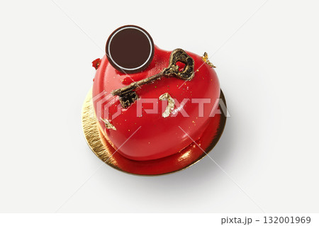 Heart-shaped red cake symbolizing love and affection with golden key decoration 132001969