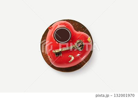 Heart-shaped red cake decorated with golden key for valentine's day or anniversary 132001970