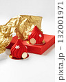 Red christmas pastry decorated with snowflakes and gold details resting on red surface 132001971