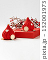 Two red christmas mousse cakes with snowflakes decoration and braun family logo 132001973