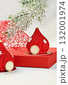 Red christmas mousse cakes decorated with snowflakes resembling santa claus hats 132001974