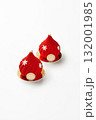 Two red christmas mousse cakes decorated with snowflakes and gold on white background 132001985