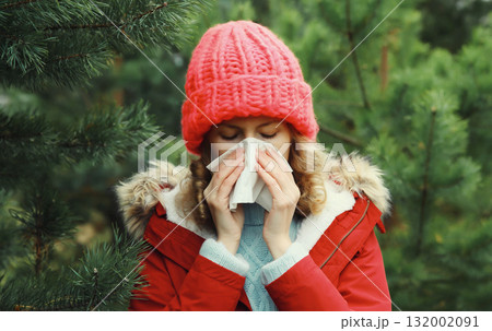 Sick exhausted woman sneezing blow nose using tissue, unhealthy suffering girl feels unwell outdoors Sick exhausted woman sneezing blow nose using tissue, unhealthy suffering girl feels unwell outdoors 132002091