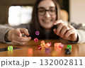 Woman stacking dice in a straight column on a table. Concentration and precision concept. 132002811