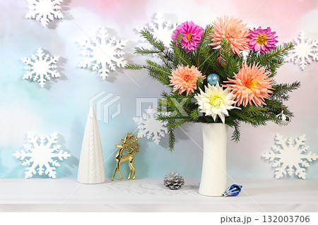 Christmas Eve concept. Christmas and New Year's mockup for design and product display, a creative Christmas bouquet of fresh fir branches in a vase with chrysanthemum flowers and decorations Christmas Eve concept. Christmas and New Year's mockup for design and product display, a creative Christmas bouquet of fresh fir branches in a vase with chrysanthemum flowers and decorations 132003706