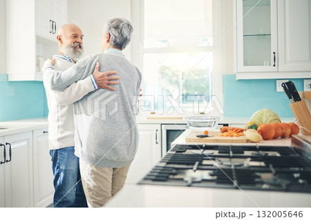 Dance, love and a senior couple in the kitchen of their home together during retirement for bonding. Happy, smile or romance with a mature man and woman pensioner dancing while having fun in a house 132005646