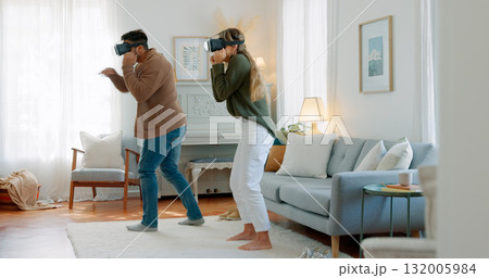 Virtual reality fight, home boxer or couple play fantasy game, interactive simulation or high tech MMA. Boxing gamer, multimedia user experience or people gaming, battle or fun esports in living room Virtual reality fight, home boxer or couple play fantasy game, interactive simulation or high tech MMA. Boxing gamer, multimedia user experience or people gaming, battle or fun esports in living room 132005984