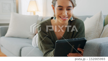 Happy woman relax on sofa with tablet, scroll and search on social media, website or email in home. Online shopping, games and girl with smile on living room couch with digital app for video download Happy woman relax on sofa with tablet, scroll and search on social media, website or email in home. Online shopping, games and girl with smile on living room couch with digital app for video download 132005993