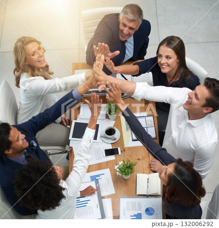 Business people, high five and teamwork in a meeting with a happy team to celebrate finance success. Above corporate men and women at table with hands, paperwork and infographics for budget or profit 132006292