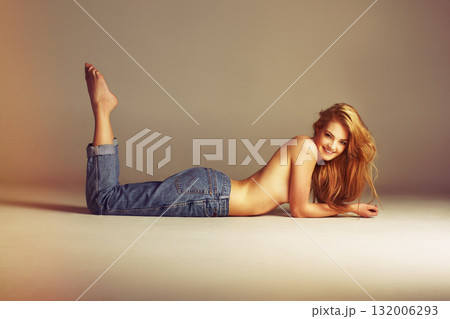 Beauty, denim and topless sexy woman on floor with long hair, designer clothes and smile on studio background. Art, aesthetic fashion and portrait of model in luxury makeup, blue jeans and mockup. Beauty, denim and topless sexy woman on floor with long hair, designer clothes and smile on studio background. Art, aesthetic fashion and portrait of model in luxury makeup, blue jeans and mockup. 132006293