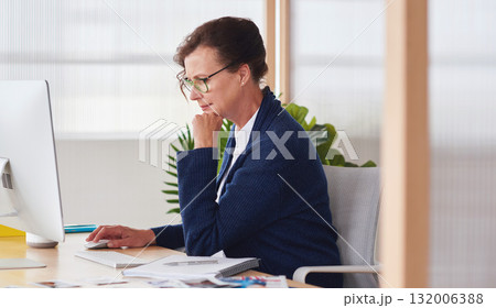 Serious, computer or graphic designer senior woman planning for creative search, web strategy or branding in office. Startup or employee at desk working on SEO transformation calendar schedule agenda 132006388