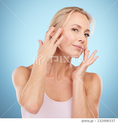 Woman touch face for beauty, skincare and blue background for wellness, cosmetics and salon spa results. Portrait, facial and studio model with healthy aesthetic, laser dermatology and natural shine Woman touch face for beauty, skincare and blue background for wellness, cosmetics and salon spa results. Portrait, facial and studio model with healthy aesthetic, laser dermatology and natural shine 132006537