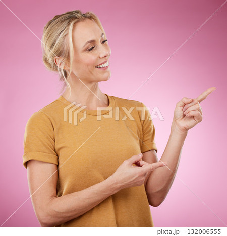 Happy, pointing and female model in studio to mockup for advertisement or product placement. Happiness, excited and woman from Canada showing with her finger mock up for marketing by pink background. Happy, pointing and female model in studio to mockup for advertisement or product placement. Happiness, excited and woman from Canada showing with her finger mock up for marketing by pink background. 132006555