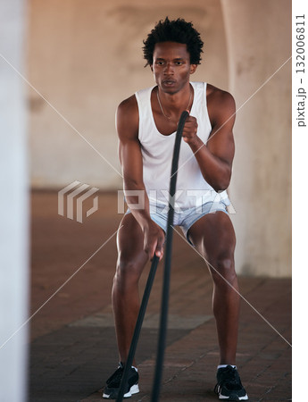 Exercise, fitness and black man with battle ropes for training workout in the city outdoors. Sports, energy and male body builder or athlete with heavy rope for strength, power or health in street. 132006811