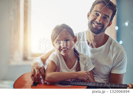 Man, young girl and guitar with teaching and learning at home, bonding with love and creativity in portrait. Family, father and daughter learn to play musical instrument, lesson and music education Man, young girl and guitar with teaching and learning at home, bonding with love and creativity in portrait. Family, father and daughter learn to play musical instrument, lesson and music education 132006894