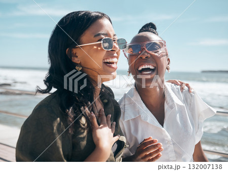 Happy, friendship and women on a walk at the beach while on a summer vacation, weekend trip or adventure. Happiness, freedom and female friends walking by the ocean while on seaside holiday together. 132007138