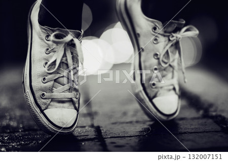 Balance, shoes or fashion in grayscale on an urban street outdoor for dance or contemporary style. Feet, sneakers or footwear in black and white in a city to explore for travel, tourism or adventure Balance, shoes or fashion in grayscale on an urban street outdoor for dance or contemporary style. Feet, sneakers or footwear in black and white in a city to explore for travel, tourism or adventure 132007151