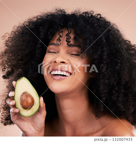 Black woman, studio and avocado for beauty, smile and skincare with health, wellness and self care by background. Happy gen z model, african and fruit for natural aesthetic, healthy nutrition or diet 132007435