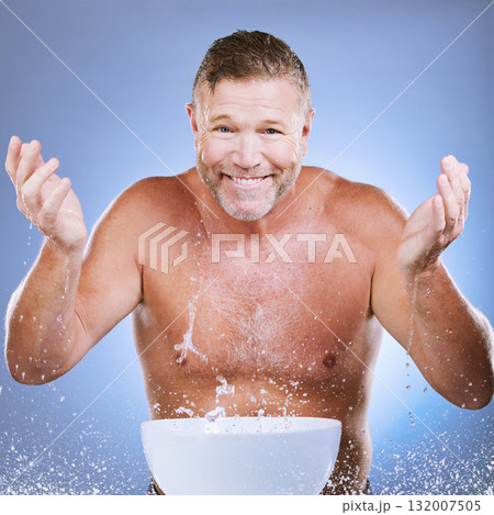 Skincare, water and man washing face in a studio for a beauty, natural and cosmetic routine. Happy, smile and portrait of a senior male model doing a facial cleansing treatment by a purple background Skincare, water and man washing face in a studio for a beauty, natural and cosmetic routine. Happy, smile and portrait of a senior male model doing a facial cleansing treatment by a purple background 132007505